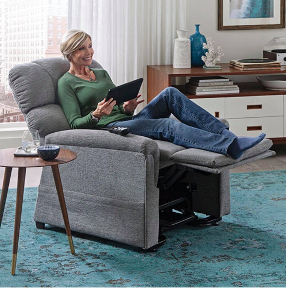 Woman relaxing in a power lift recliner from MacPherson's Medical Supply, trusted provider of home medical equipment in RGV.