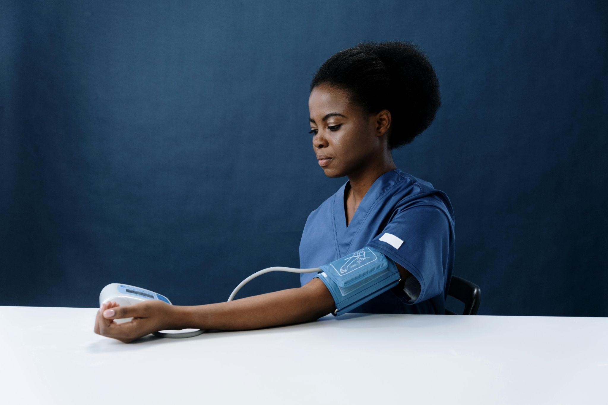 Woman using blood pressure monitoring device