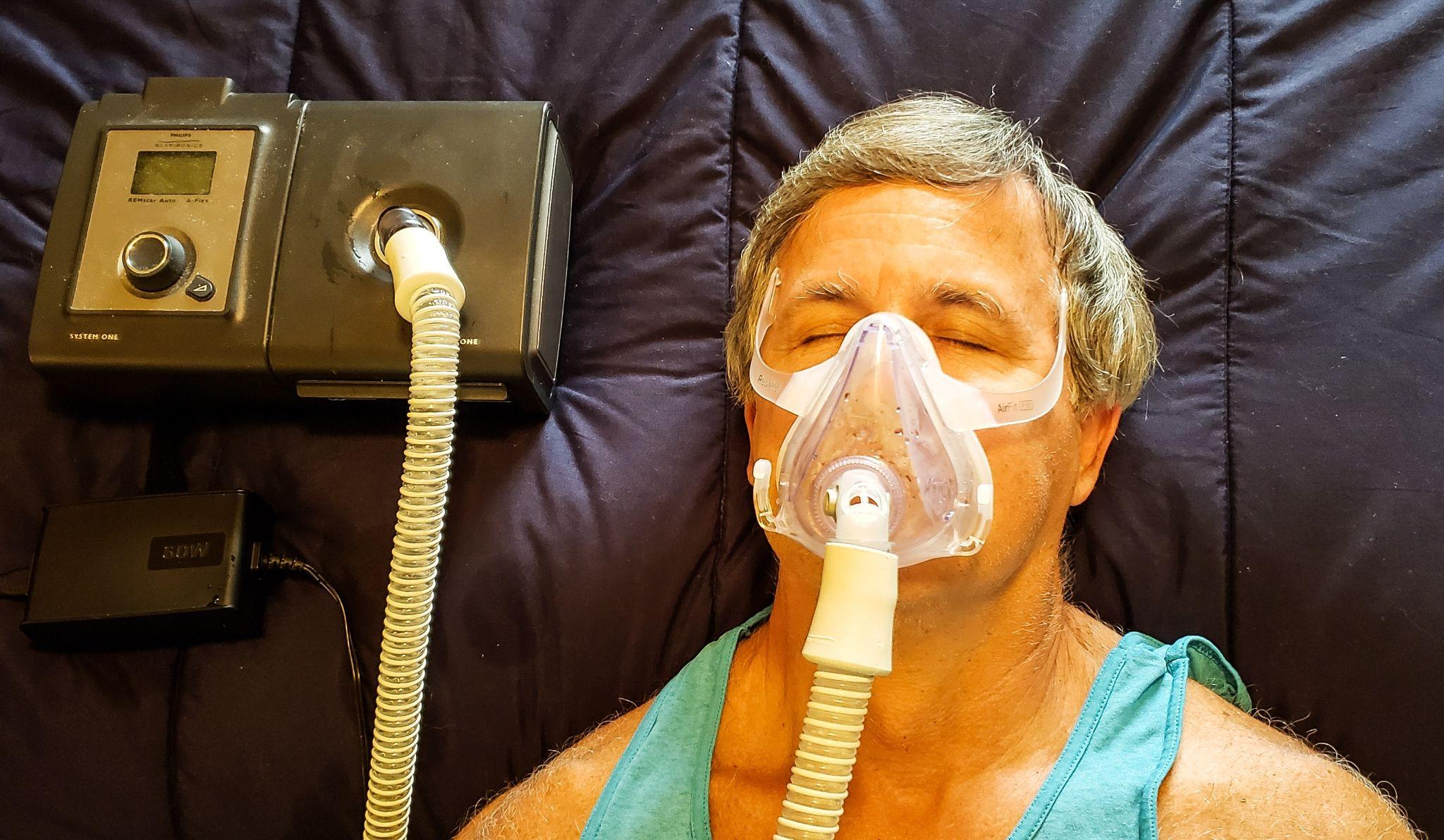 man using respiratory therapy device