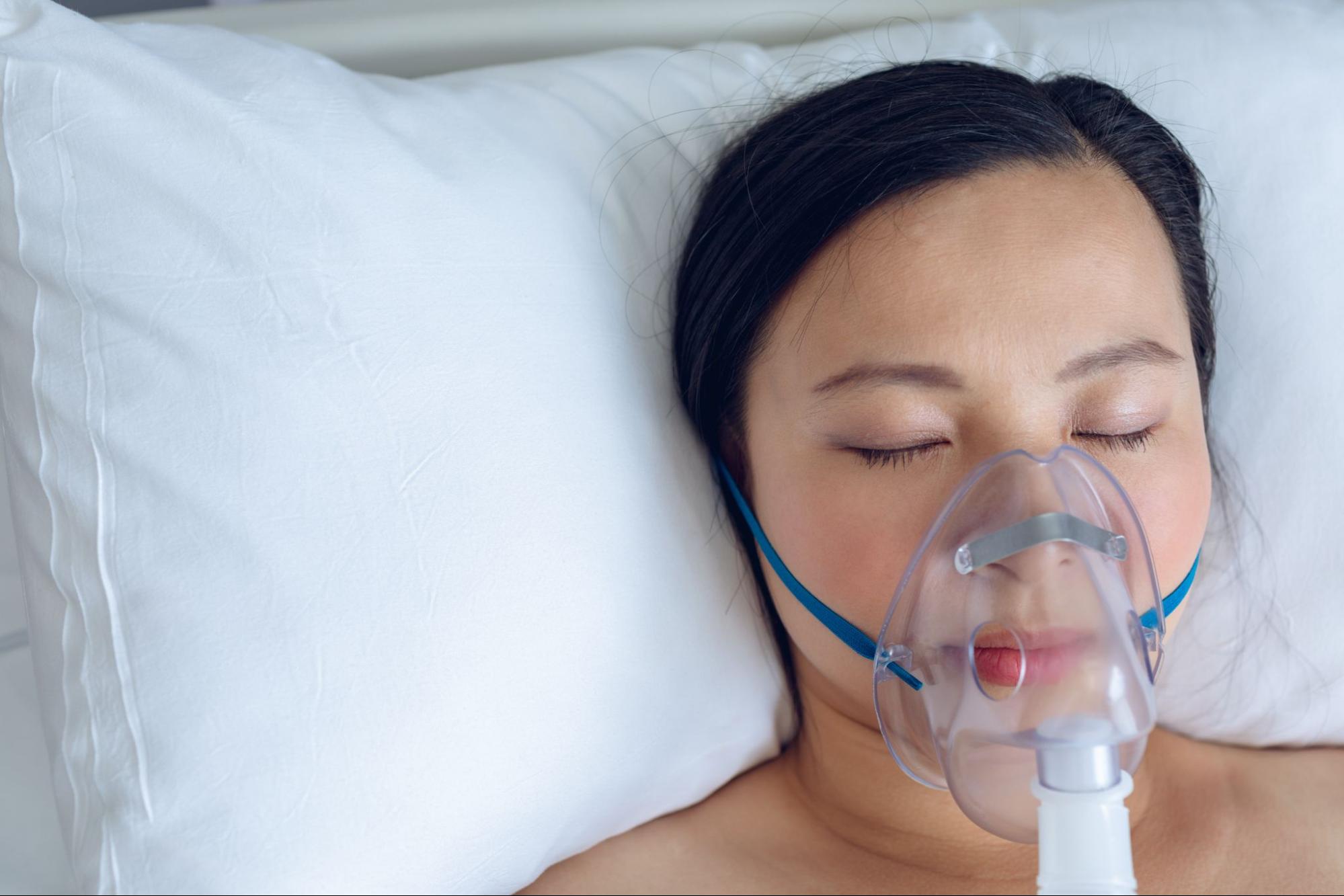 Woman sleeping comfortably while wearing a CPAP mask.