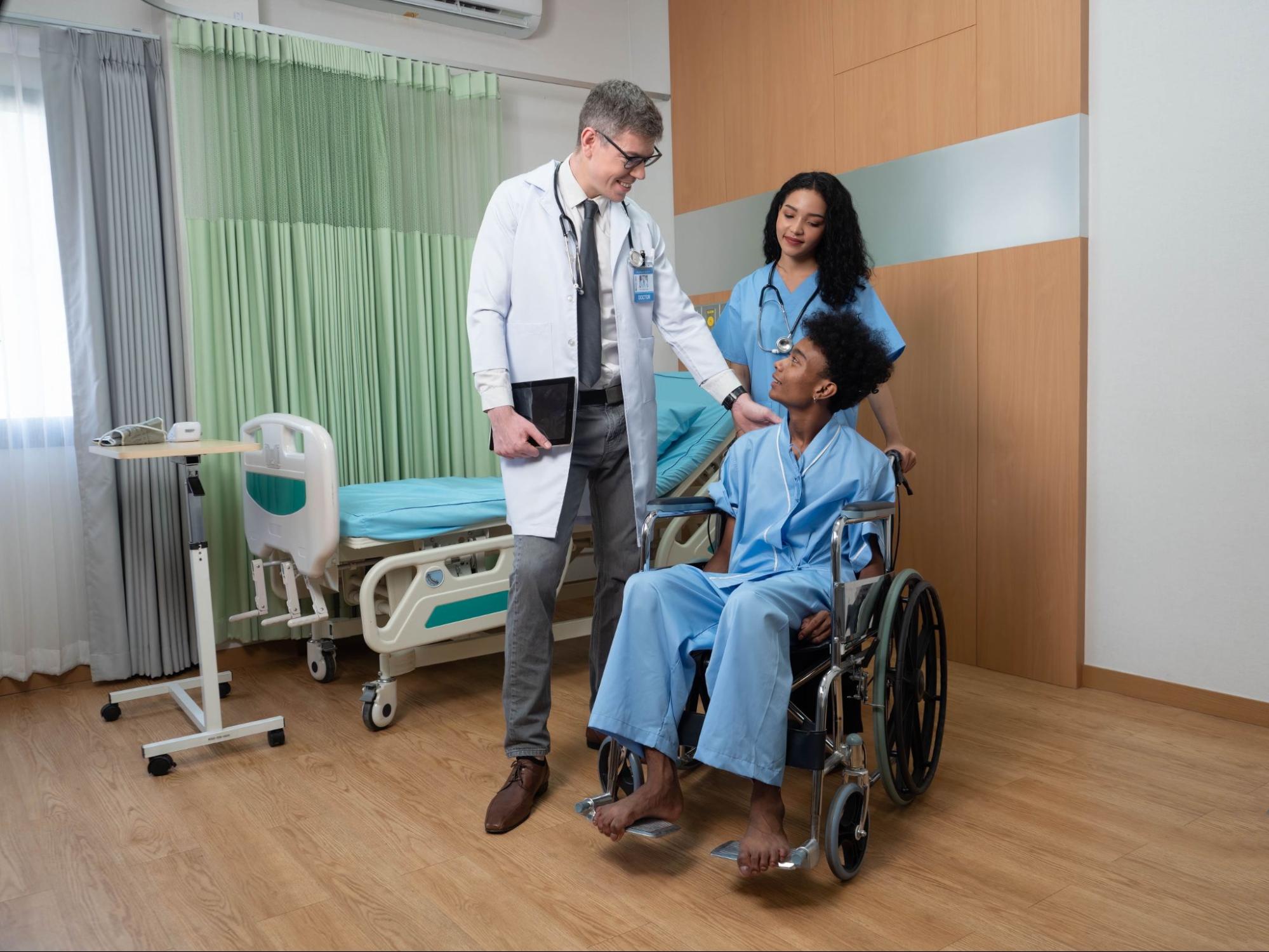 doctor and nurse congratulating a hospital patient in a wheelchair during discharge, symbolizing compassionate medical supply distribution and patient care