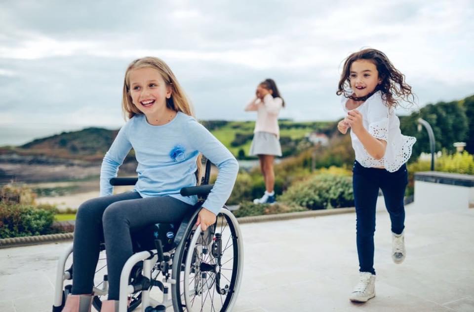 girl on wheelchair with friends