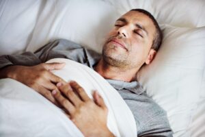 man sleeping in bed