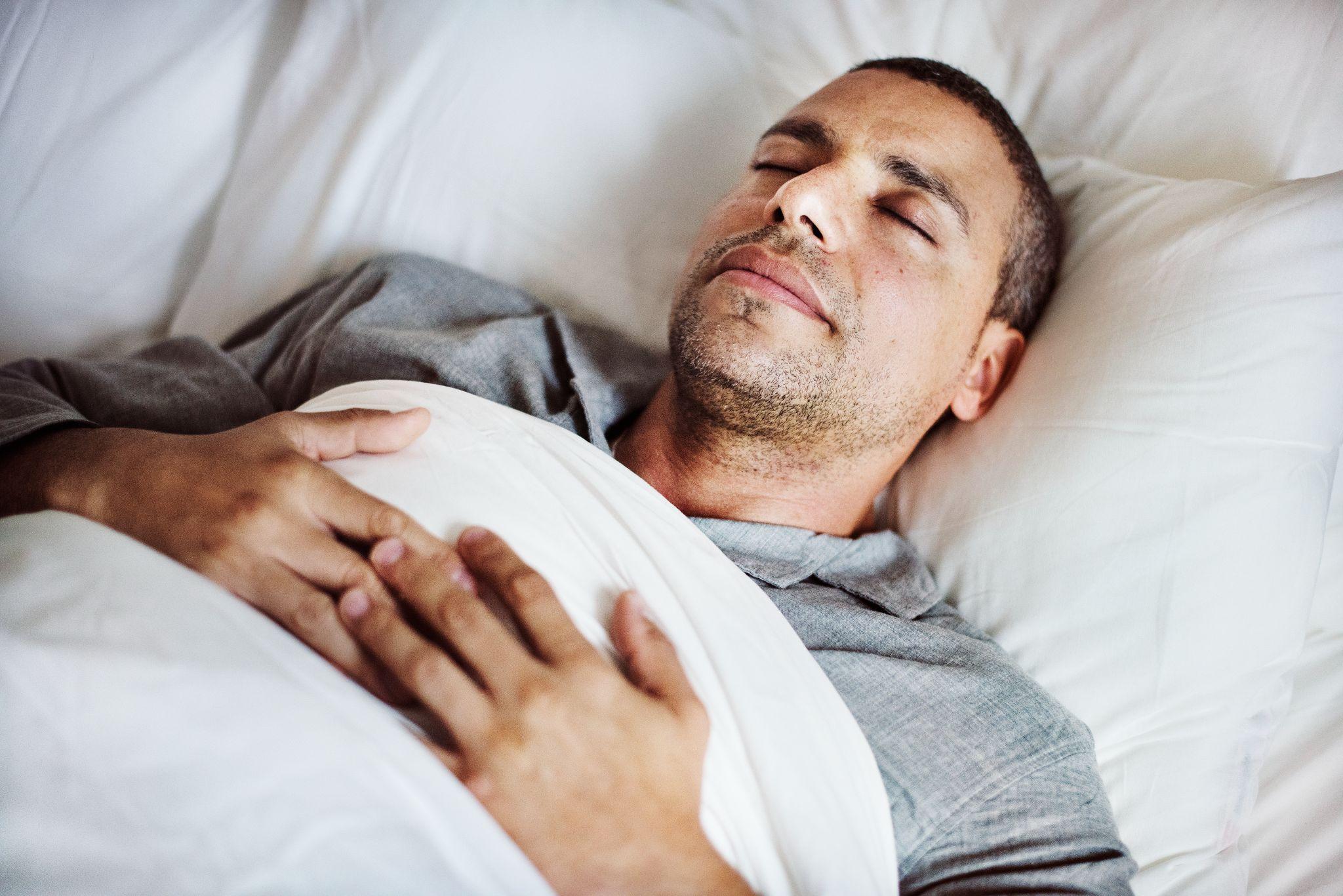 man sleeping in bed