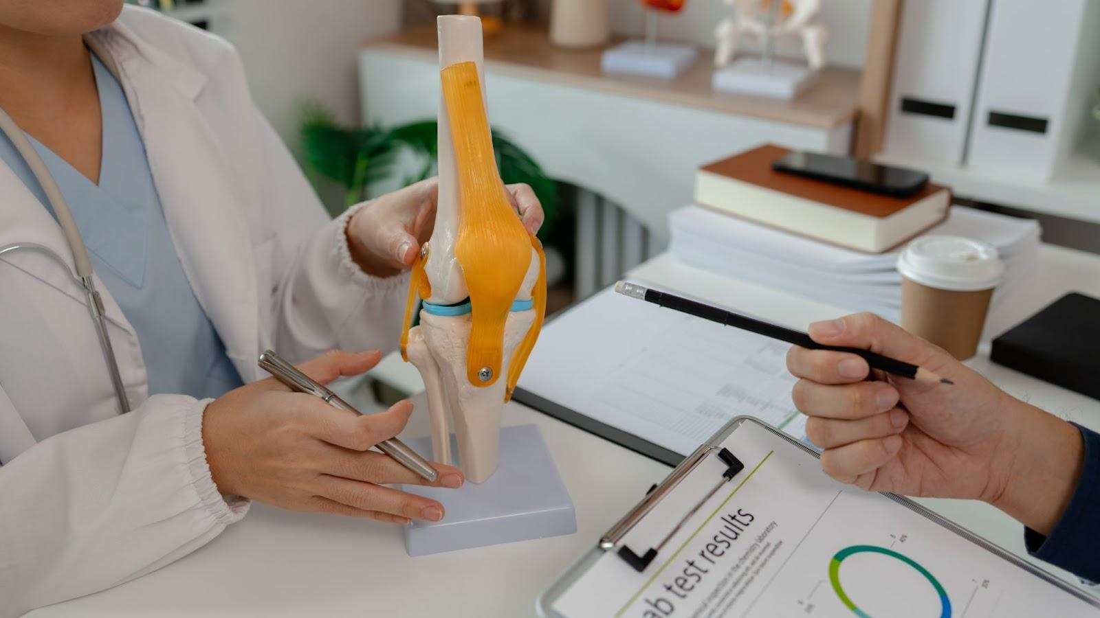 Technician shaping and preparing a custom foot orthotic in a medical supply lab to improve posture, gait, and long-term stability