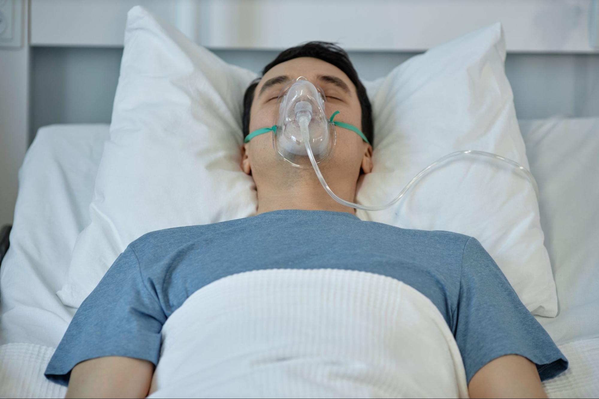 Person using BiPAP vs CPAP mask during sleep for open airway support.