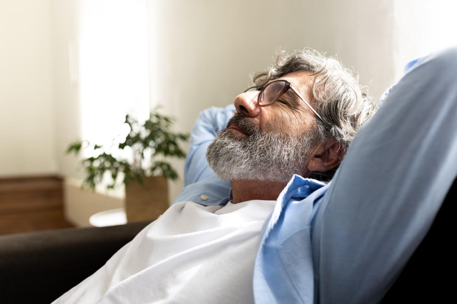 Elderly man resting peacefully and breathing easily during sleep.