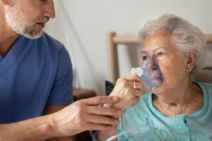 Senior using a portable oxygen concentrator in their home, supported by a local medical supplier