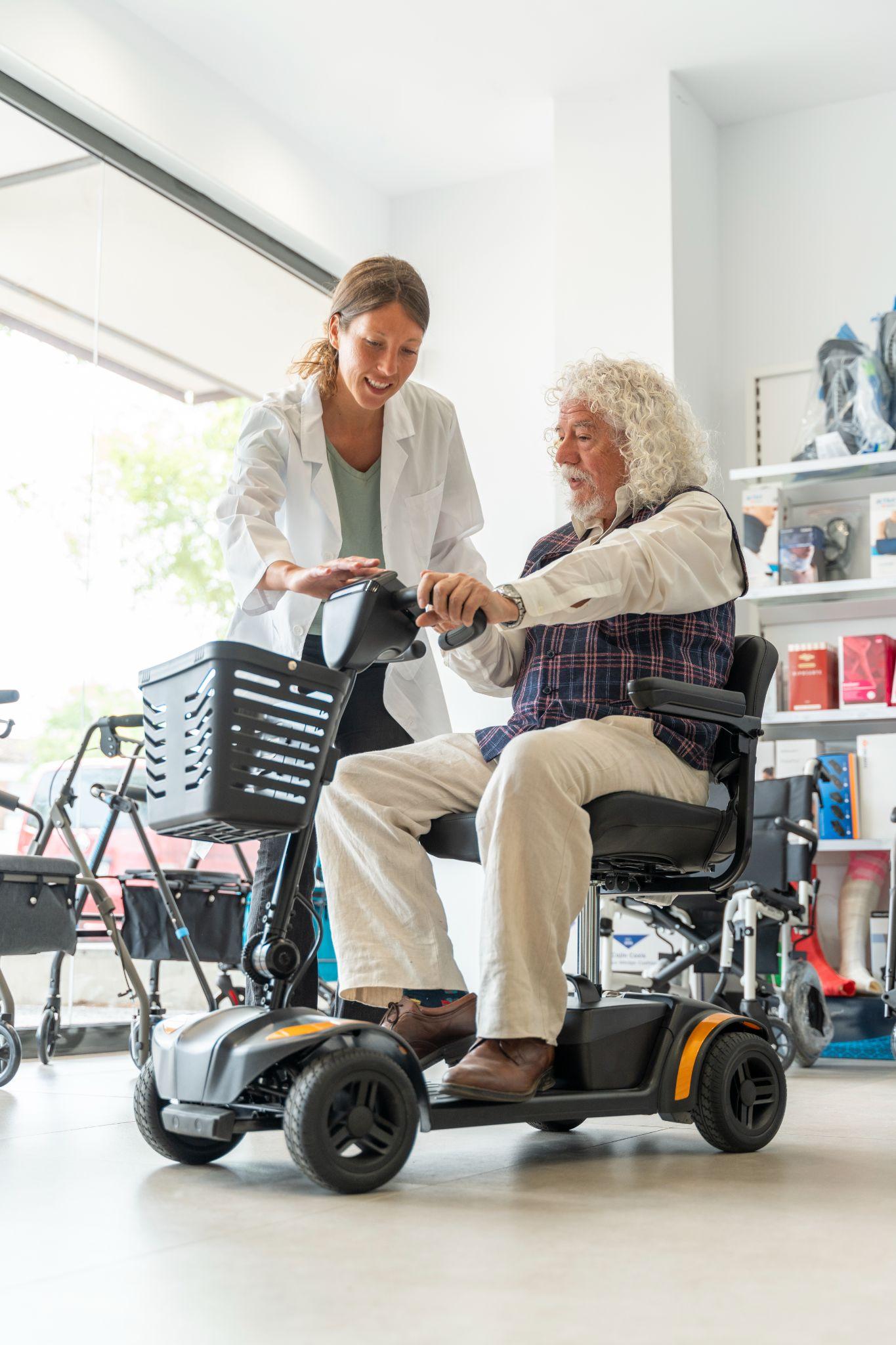 elderly man trying out an electric scooter