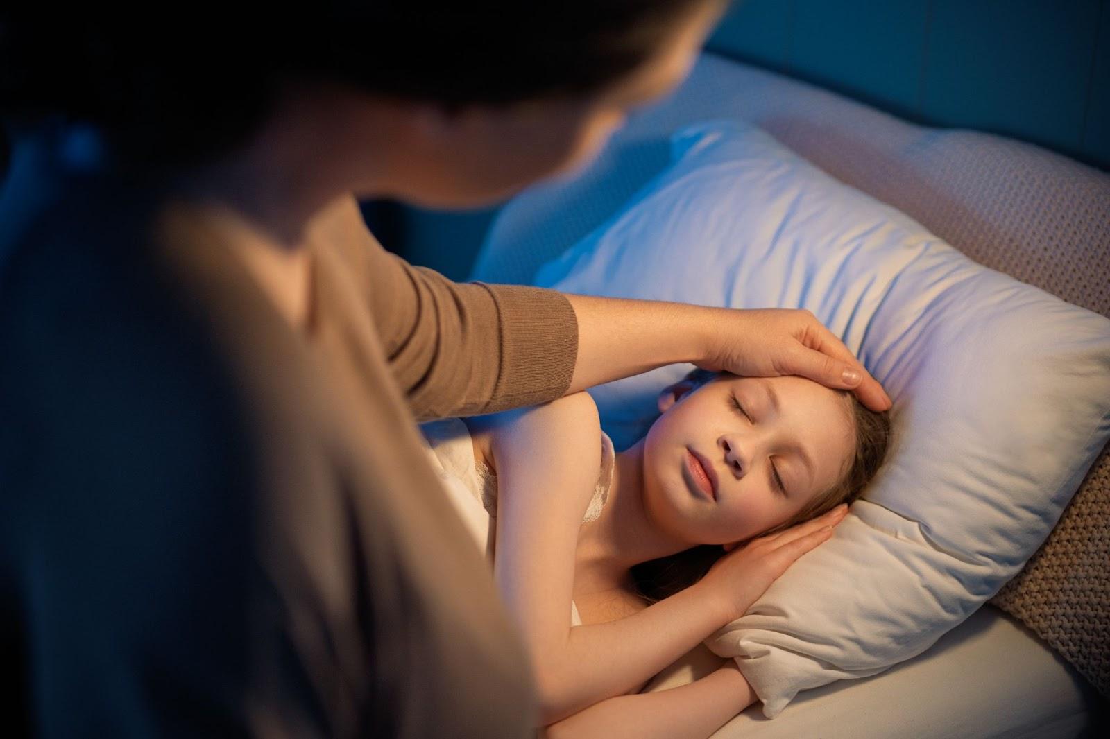 Parent gently ensuring a child’s peaceful, healthy sleep.