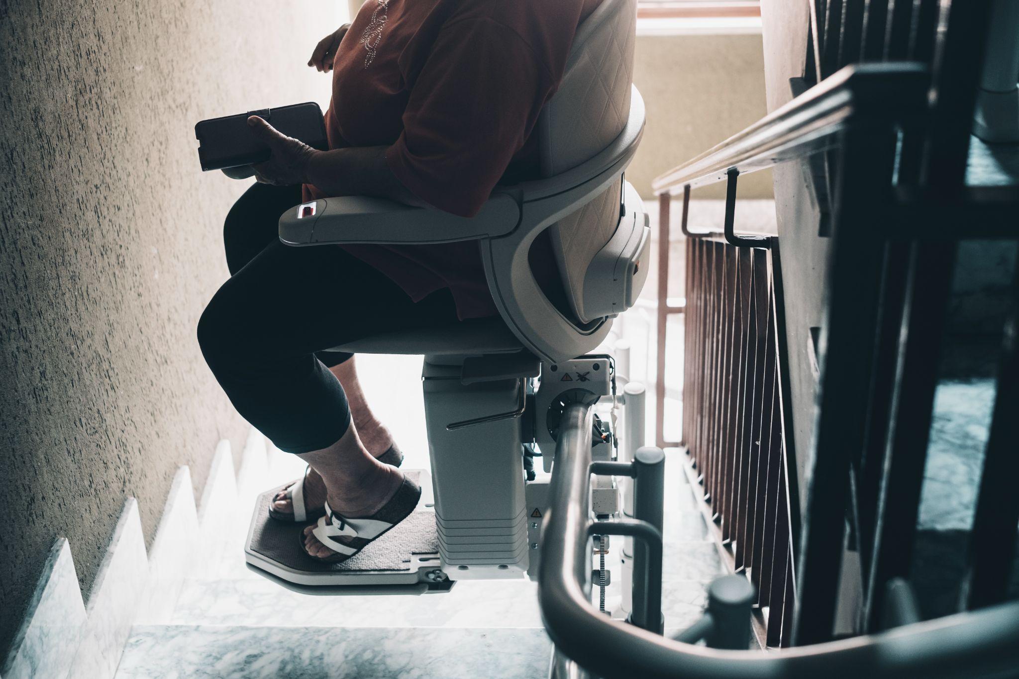 Elderly using a stair lift