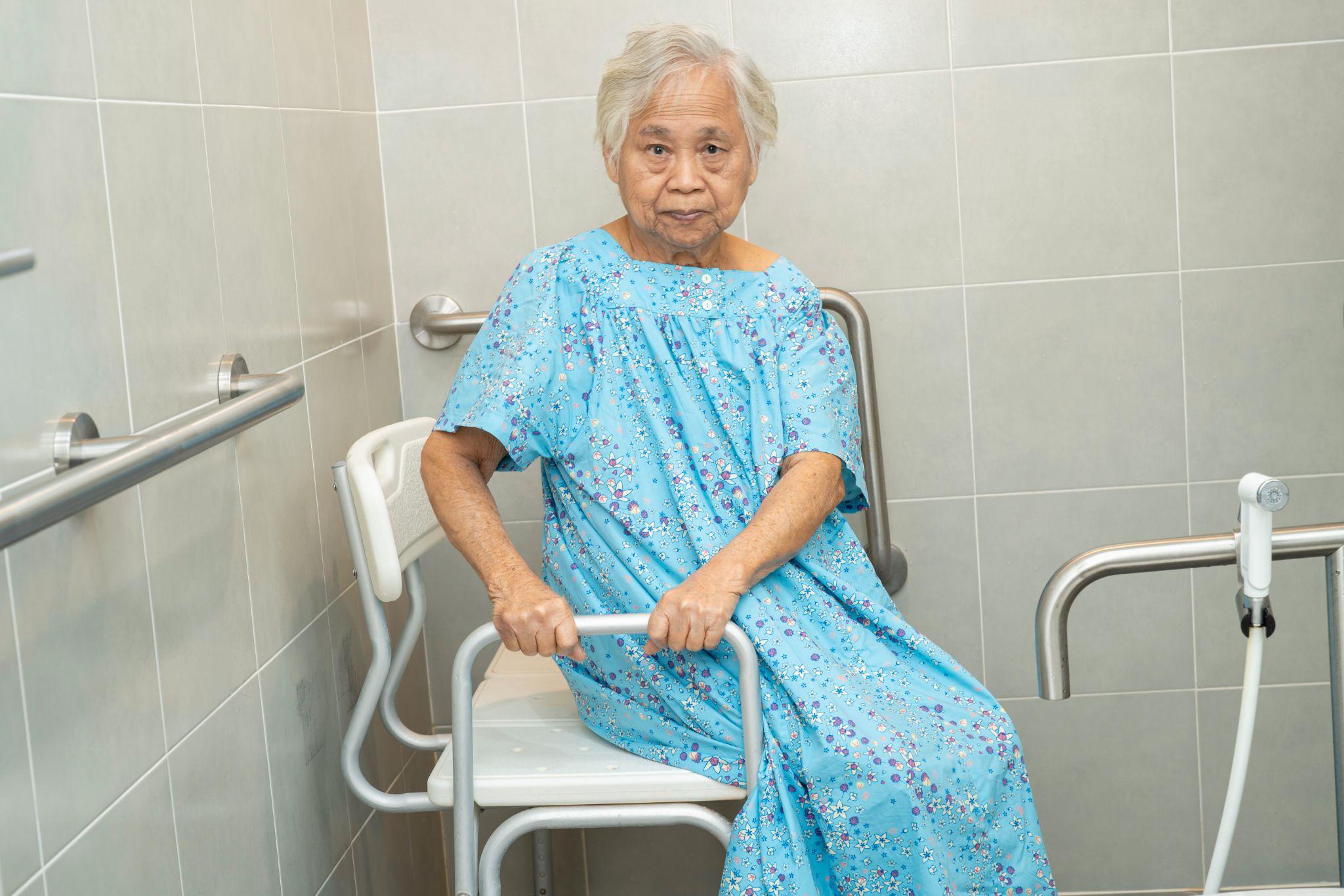 woman sitting on shower chair