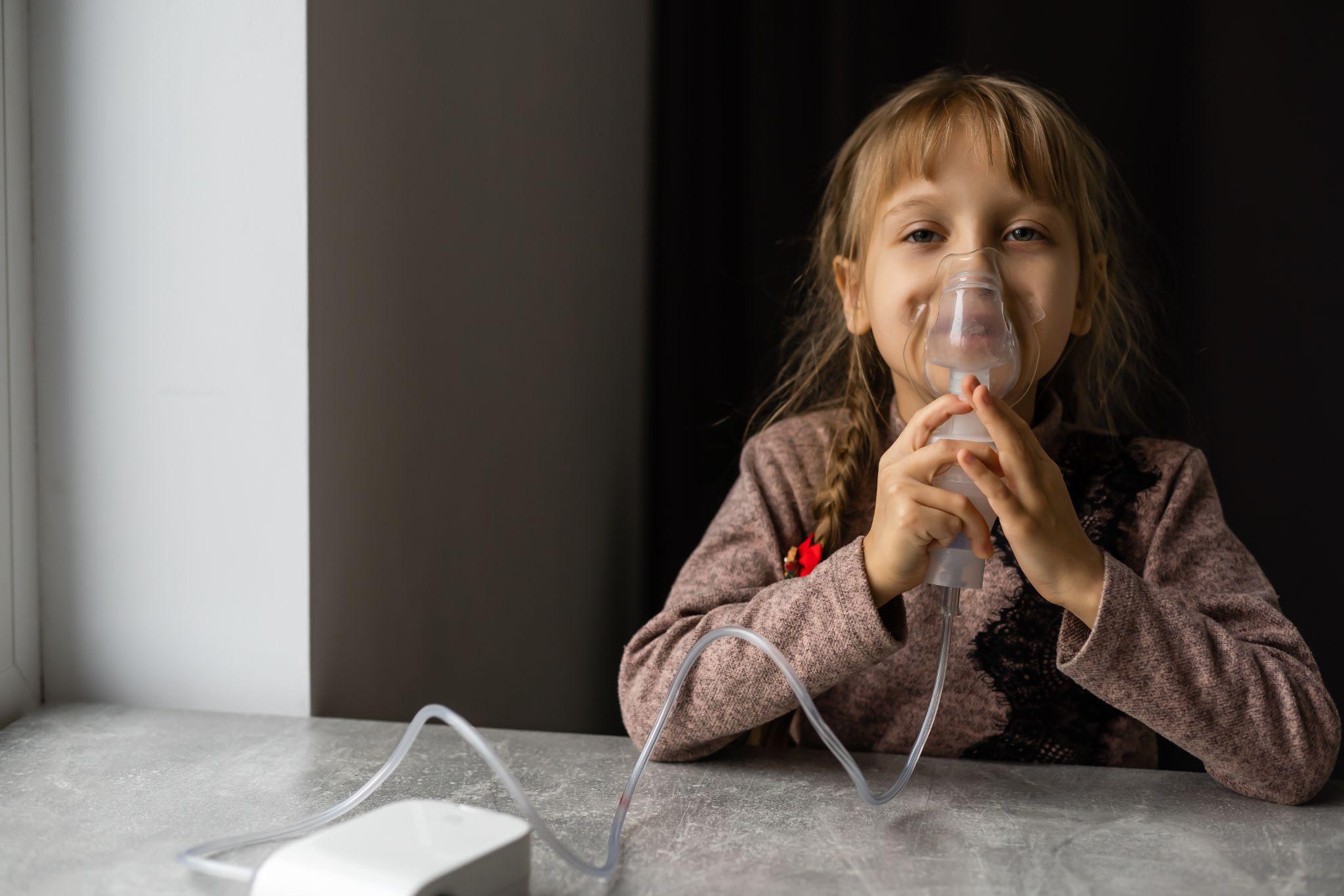 child using nebulizer at home