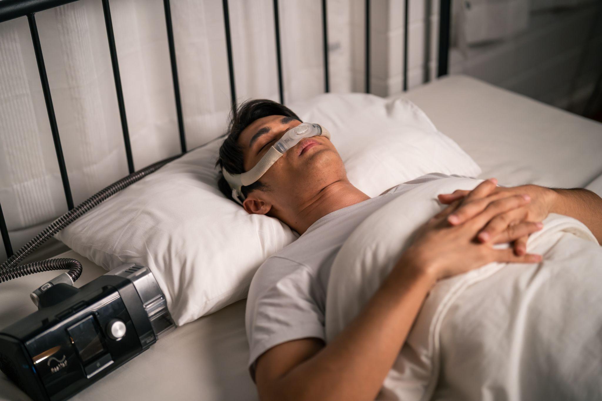 man using CPAP machine, showing the importance of home healthcare advice for such devices