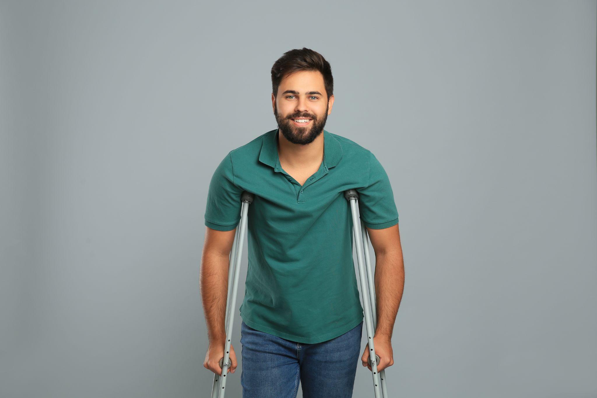 man using axillary crutches