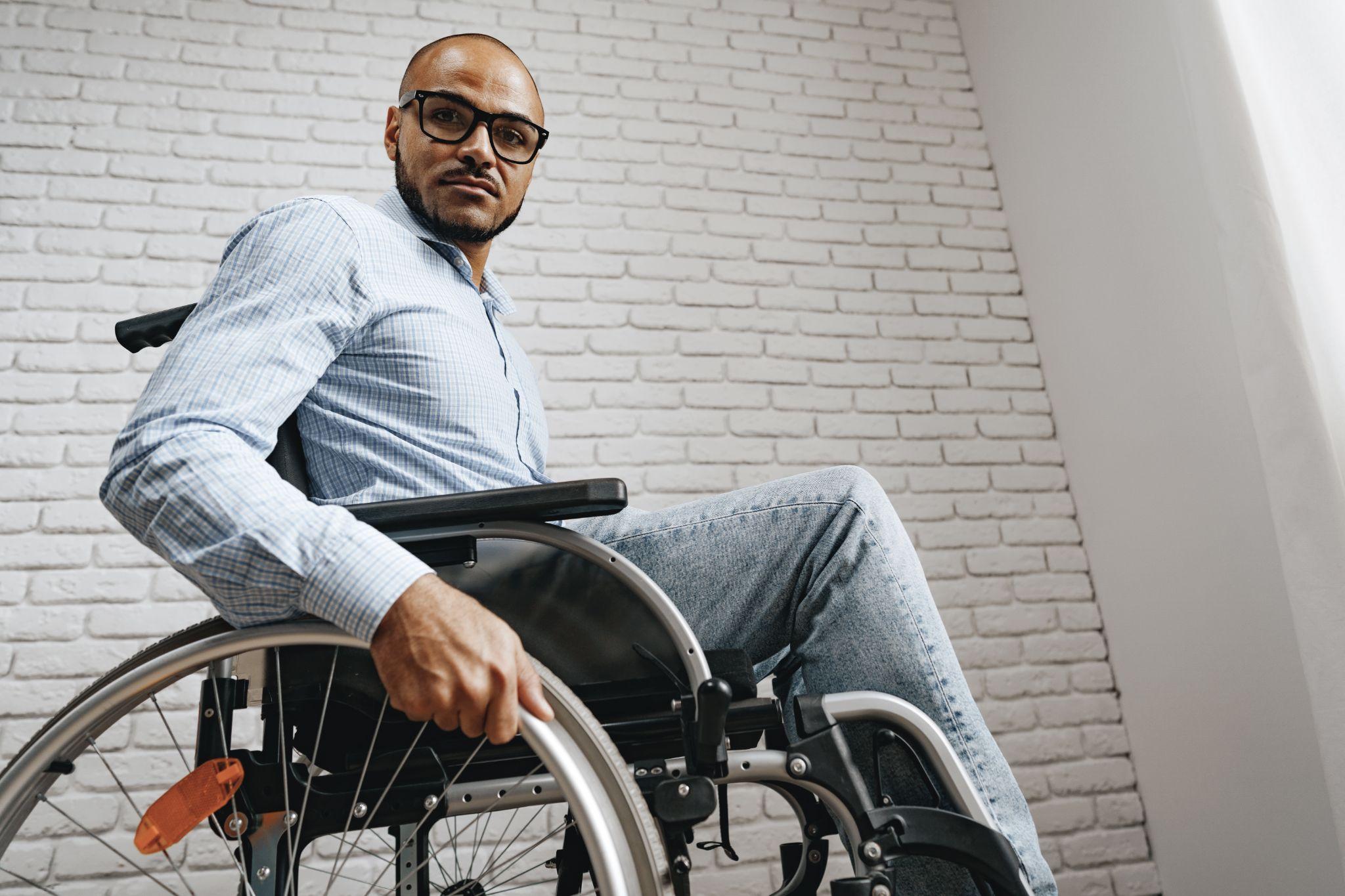man using wheelchair, highlighting the need for equipment maintenance for medical devices