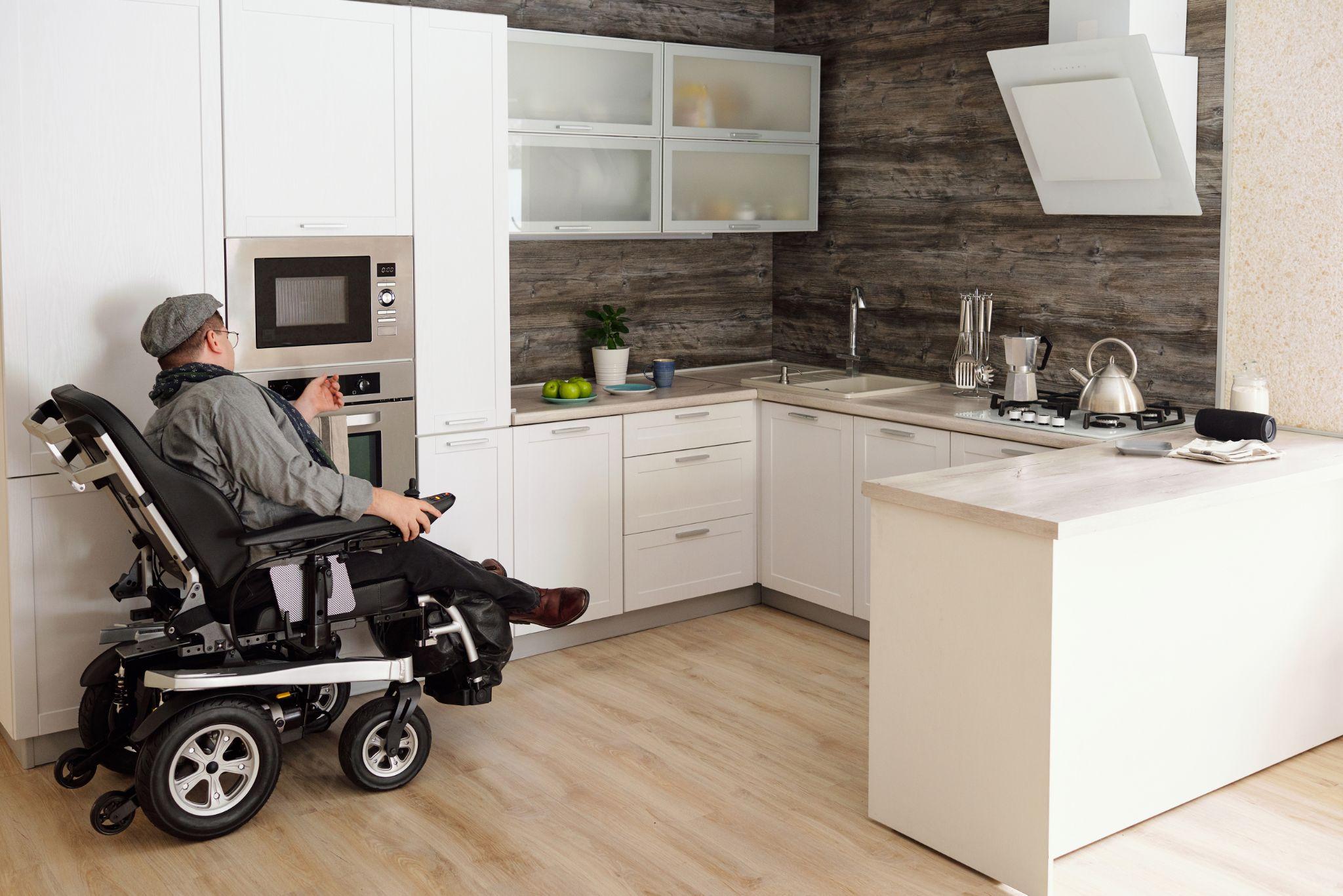 man in power wheelchair at home