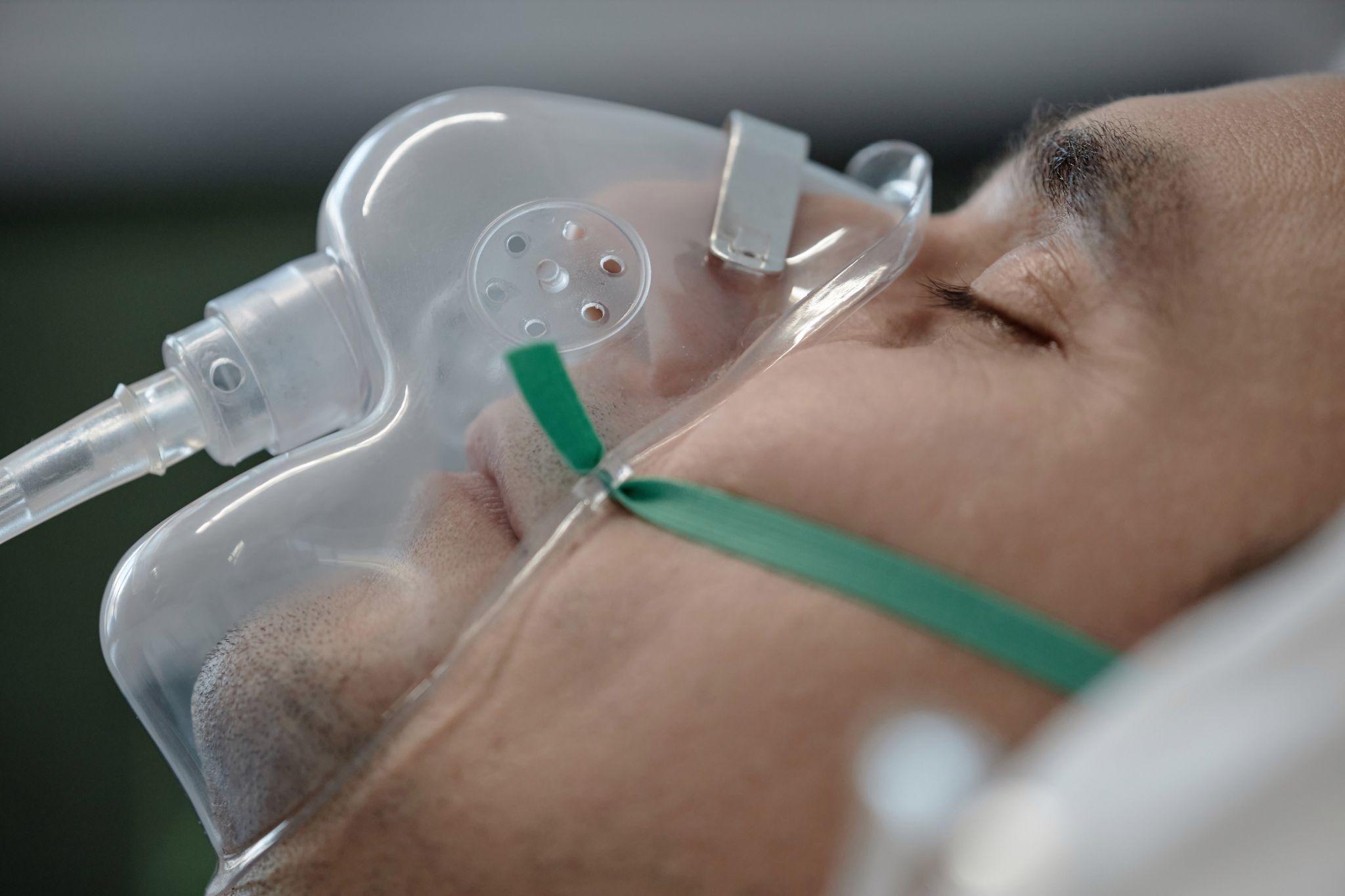 Man resting peacefully while using a nasal CPAP mask for sleep apnea therapy.