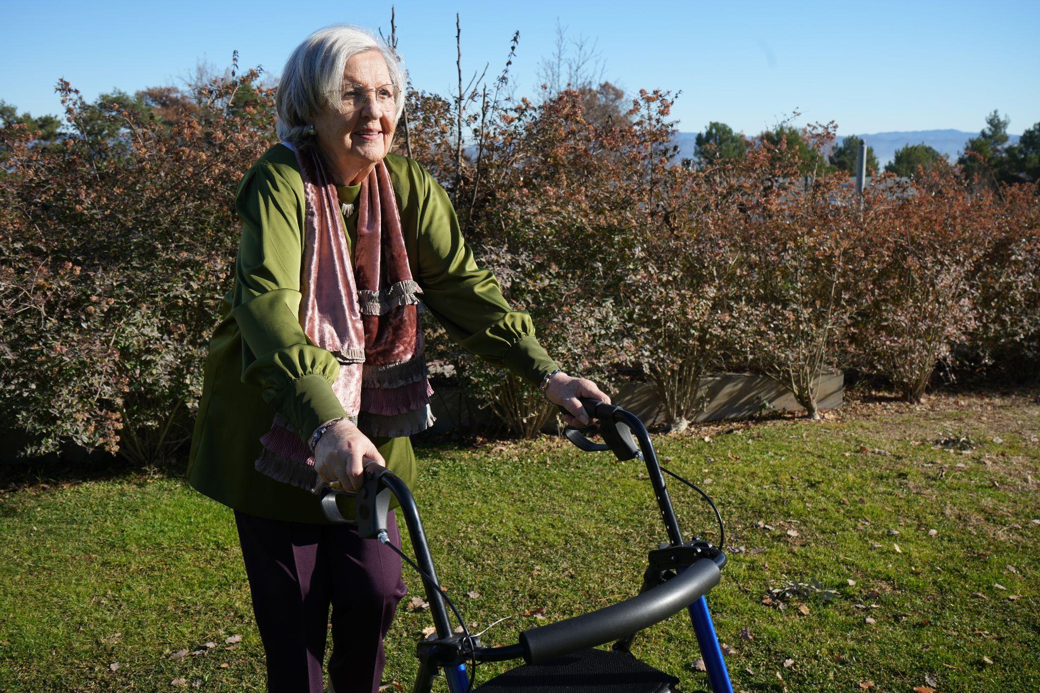 woman using rollator in her garden