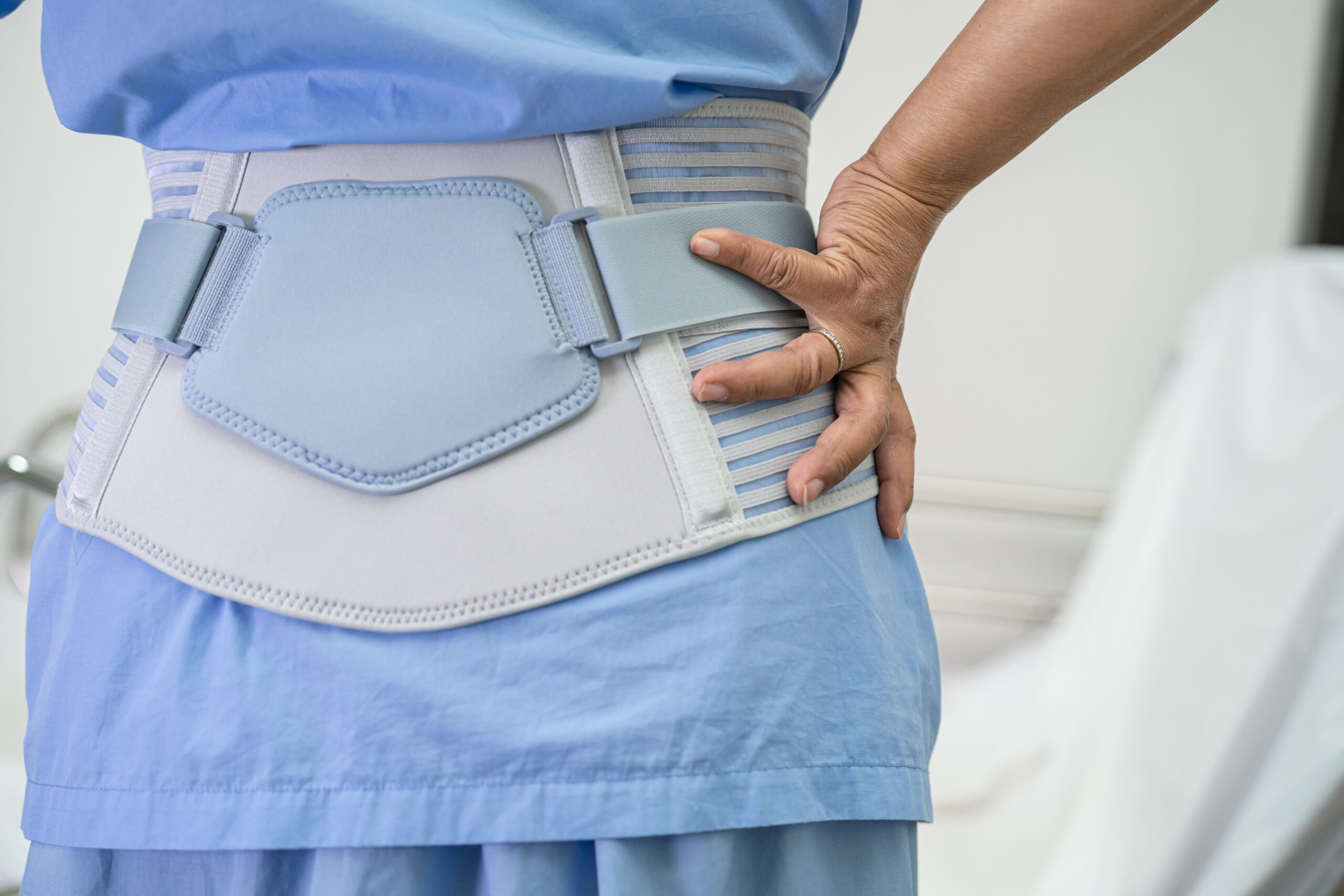 Patient wearing lumbar support brace