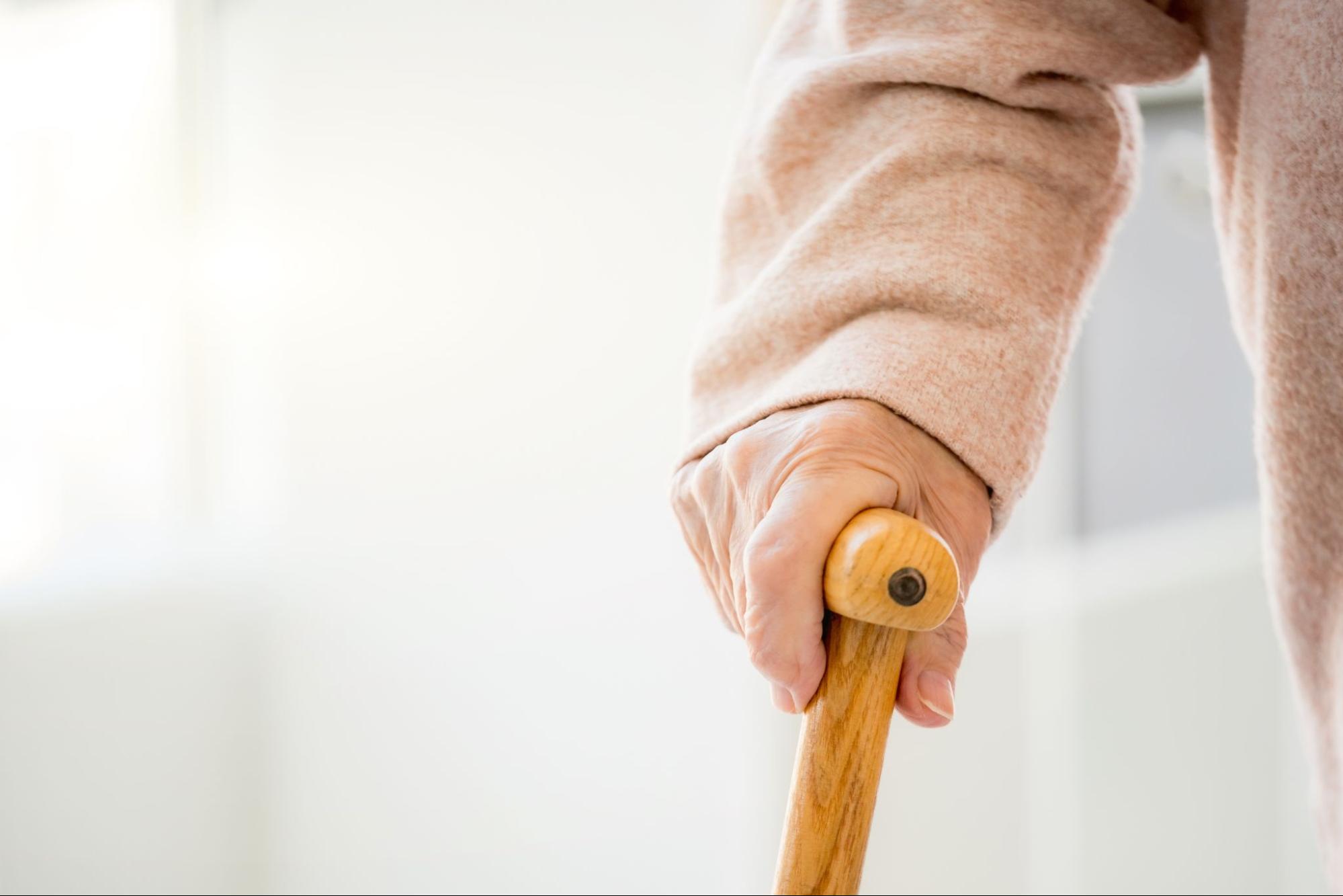 Close-up of elderly hand holding cane showing mobility aid from a Medicare DME supplier