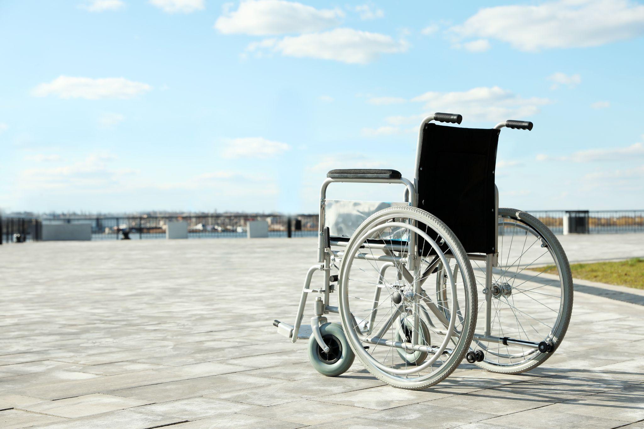 Empty wheelchair outdoors on a sunny day