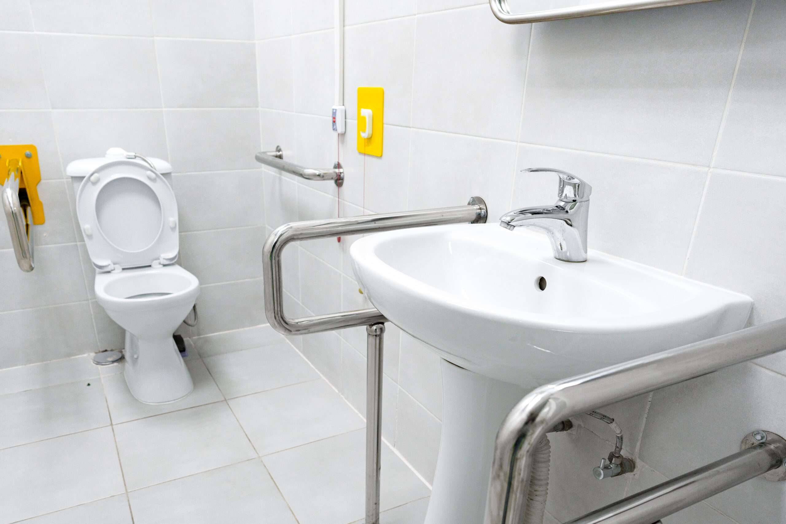 bathroom with grab bars and accessibility features