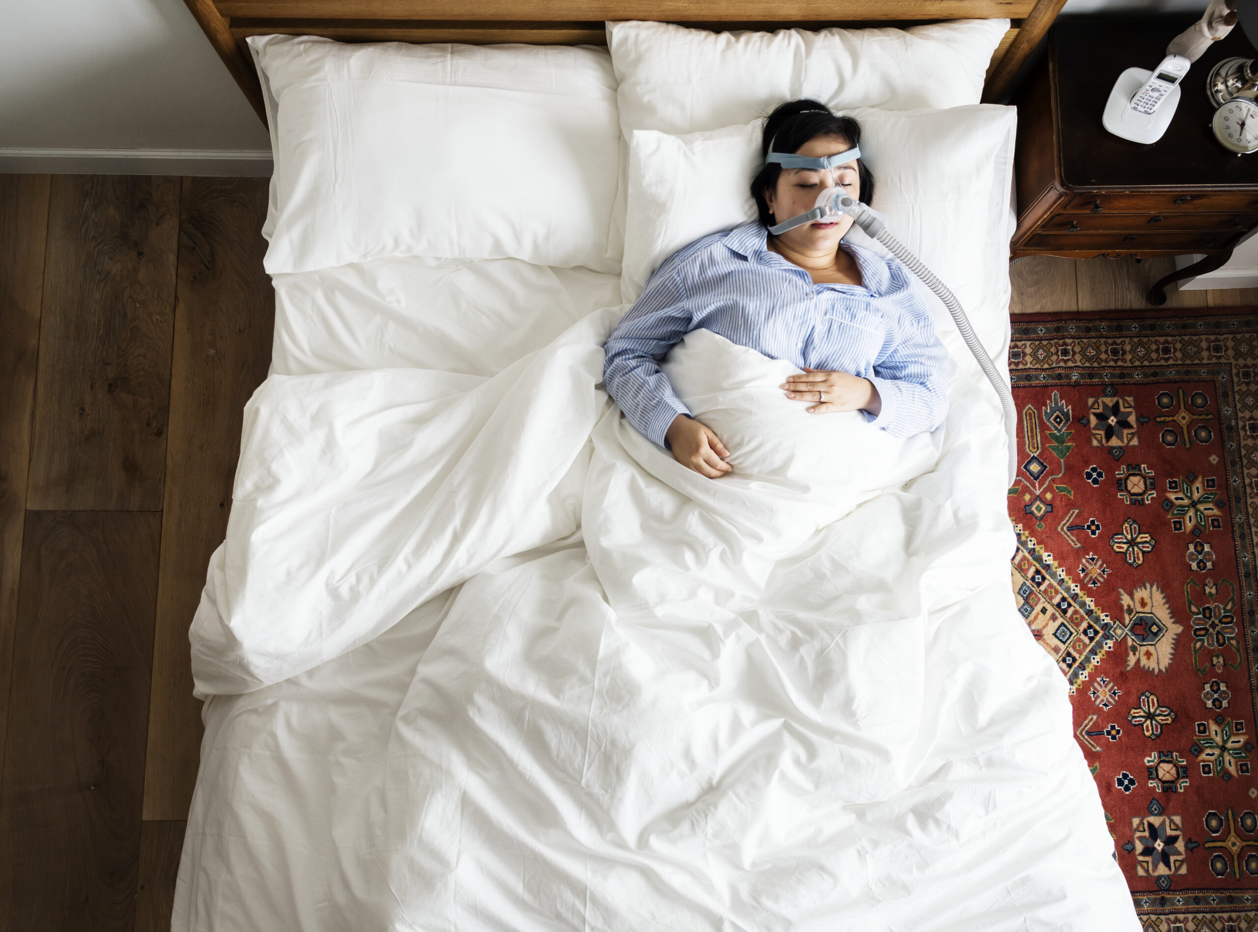 woman using CPAP machine while sleeping