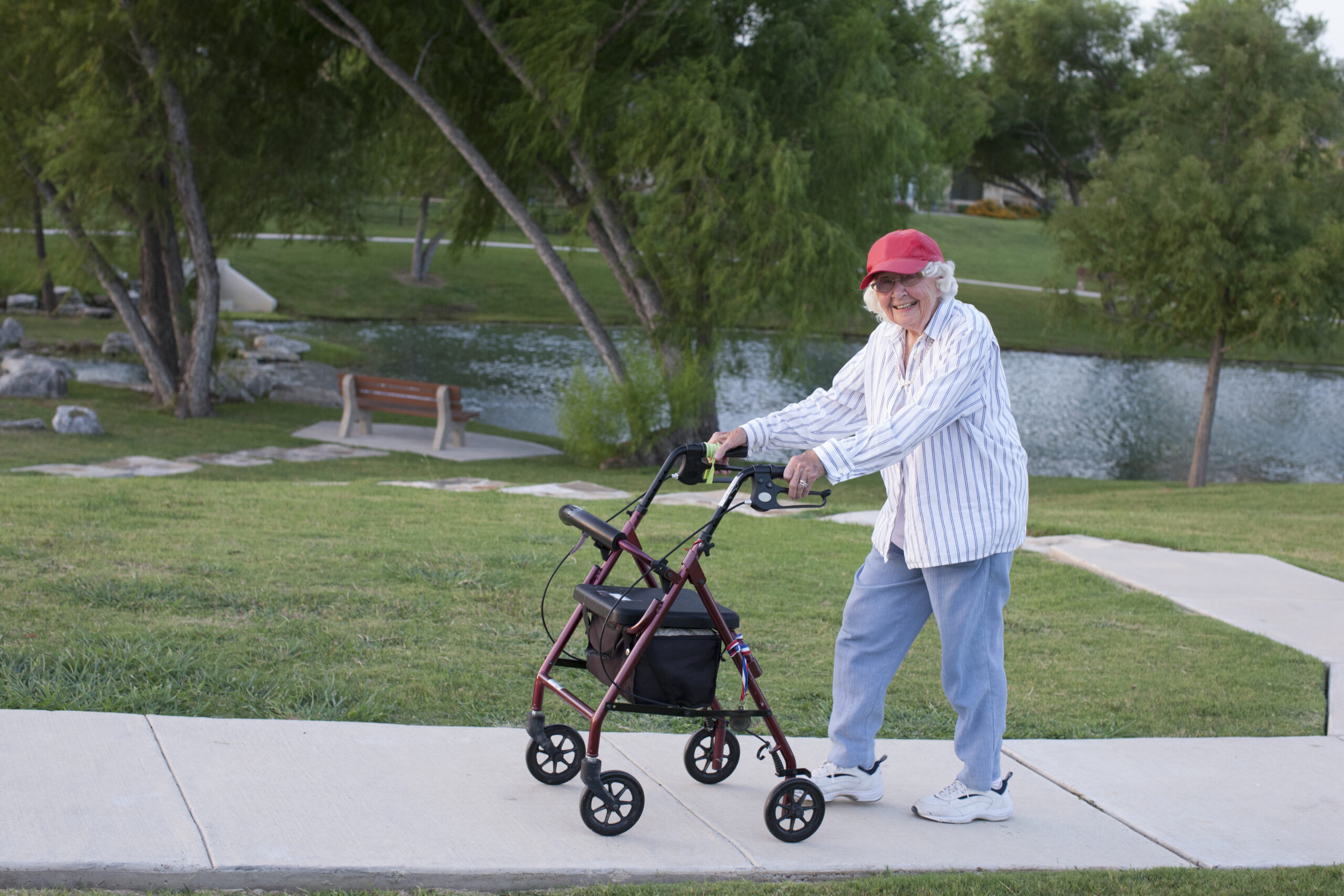 Senior woman walking outdoors with rollator