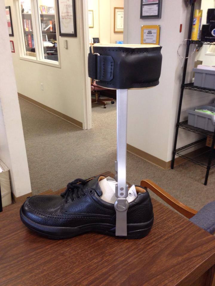 A custom ankle-foot orthotic leg brace attached to a black shoe, crafted through custom orthotic fabrication in South Texas.