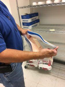 Technician showcasing a handcrafted shoe insert during custom orthotic fabrication in South Texas at MacPherson's Medical Supply.