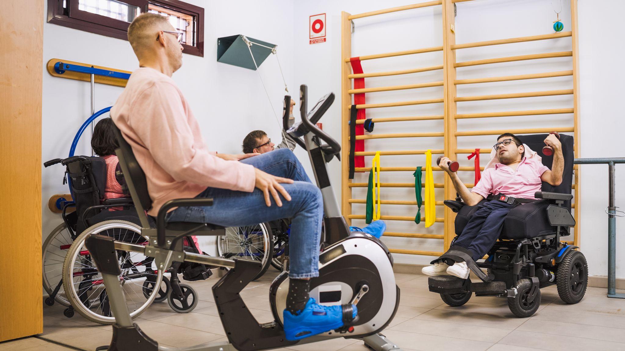 People using manual and power wheelchairs during rehabilitation exercises, highlighting complex rehab equipment in Harlingen for mobility and support.