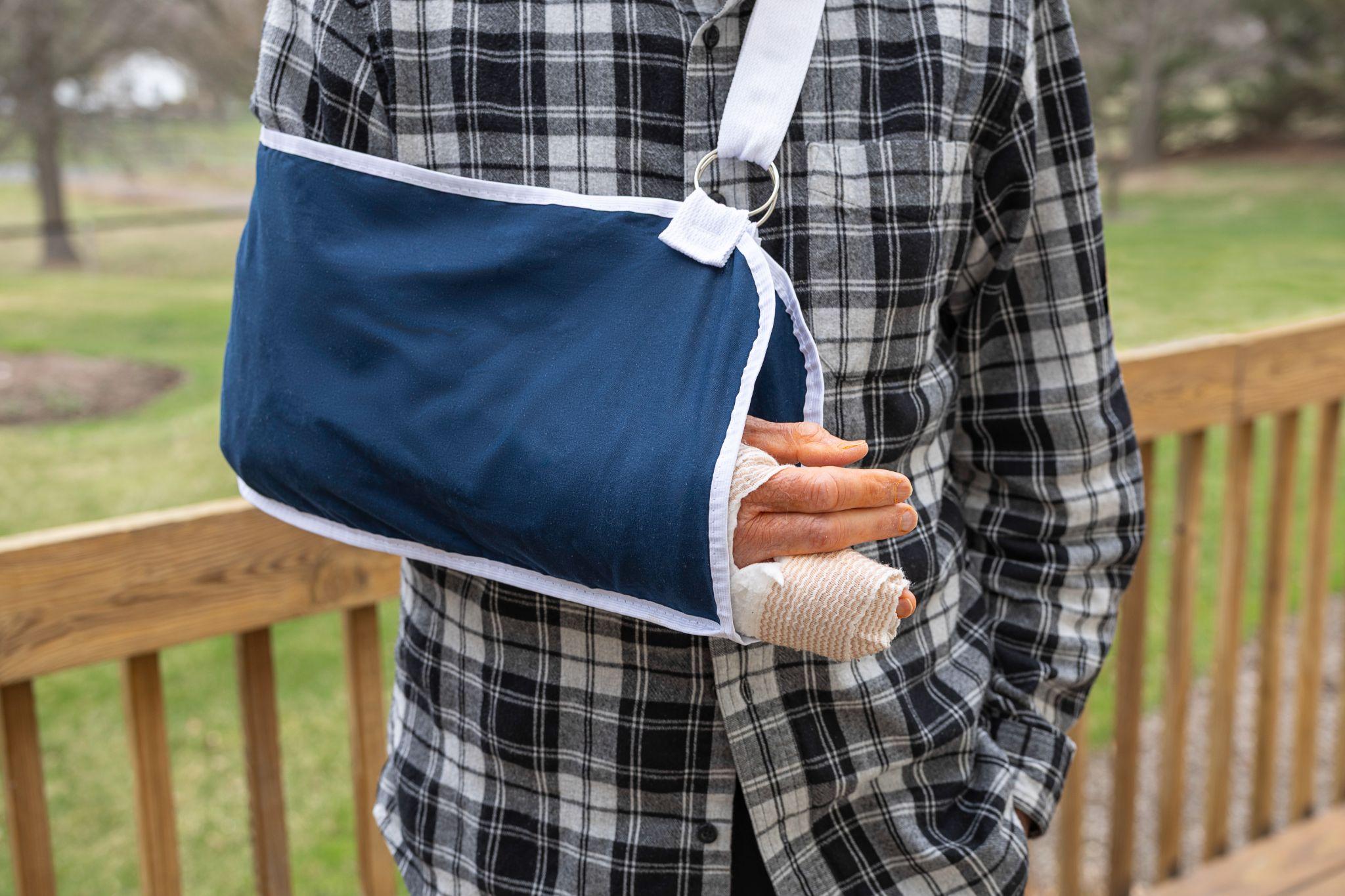 Person wearing a shoulder immobilizer to support an injured arm during recovery.