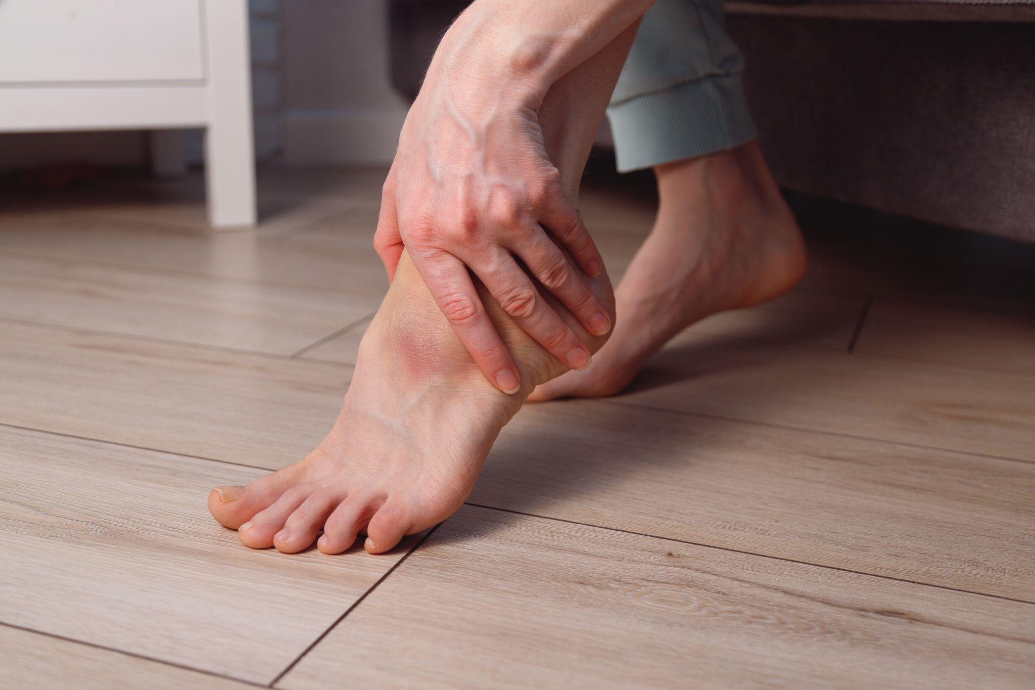 Person experiencing foot discomfort before considering custom insoles