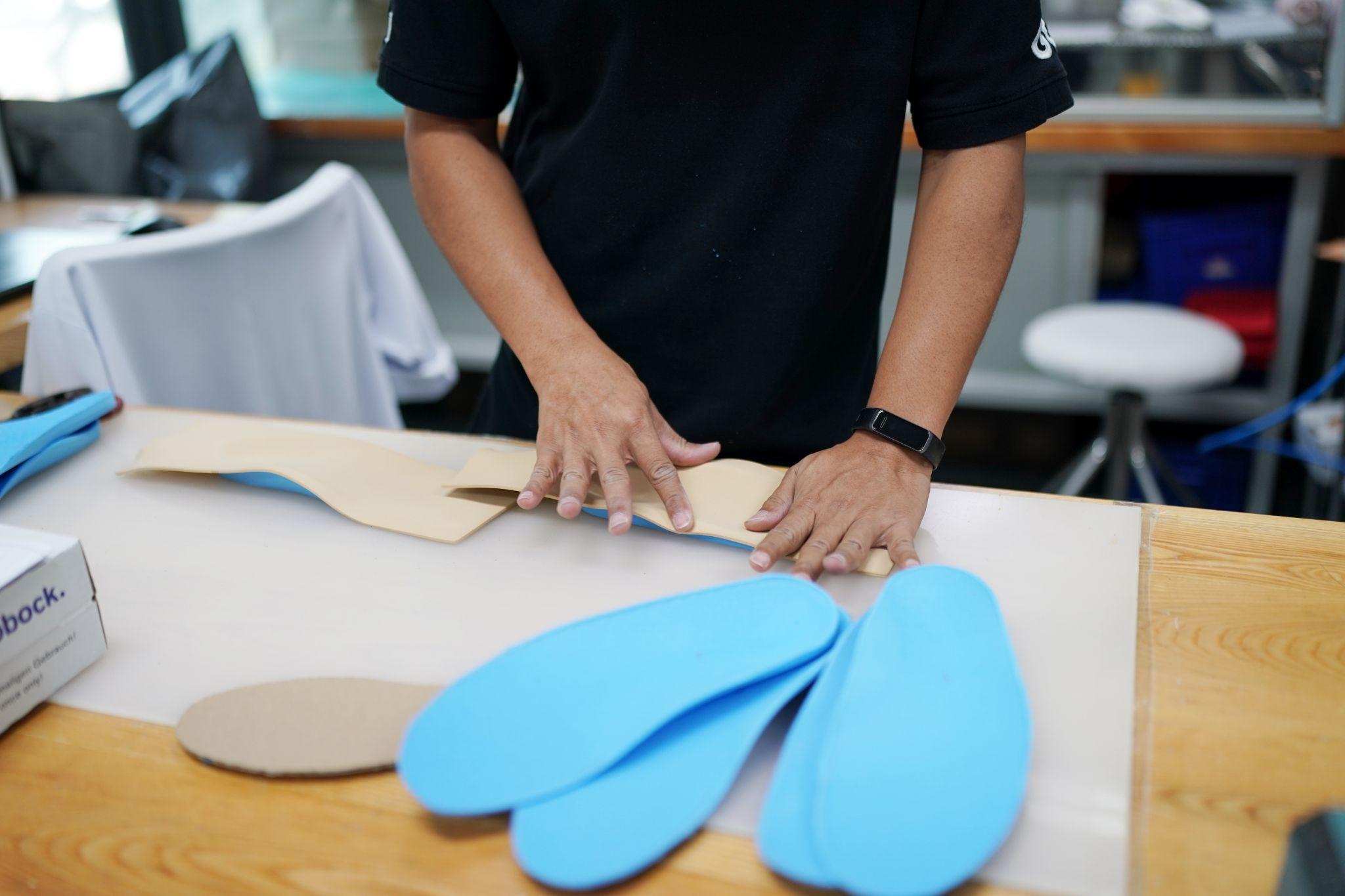 Custom insoles being shaped and prepared for an individual fit