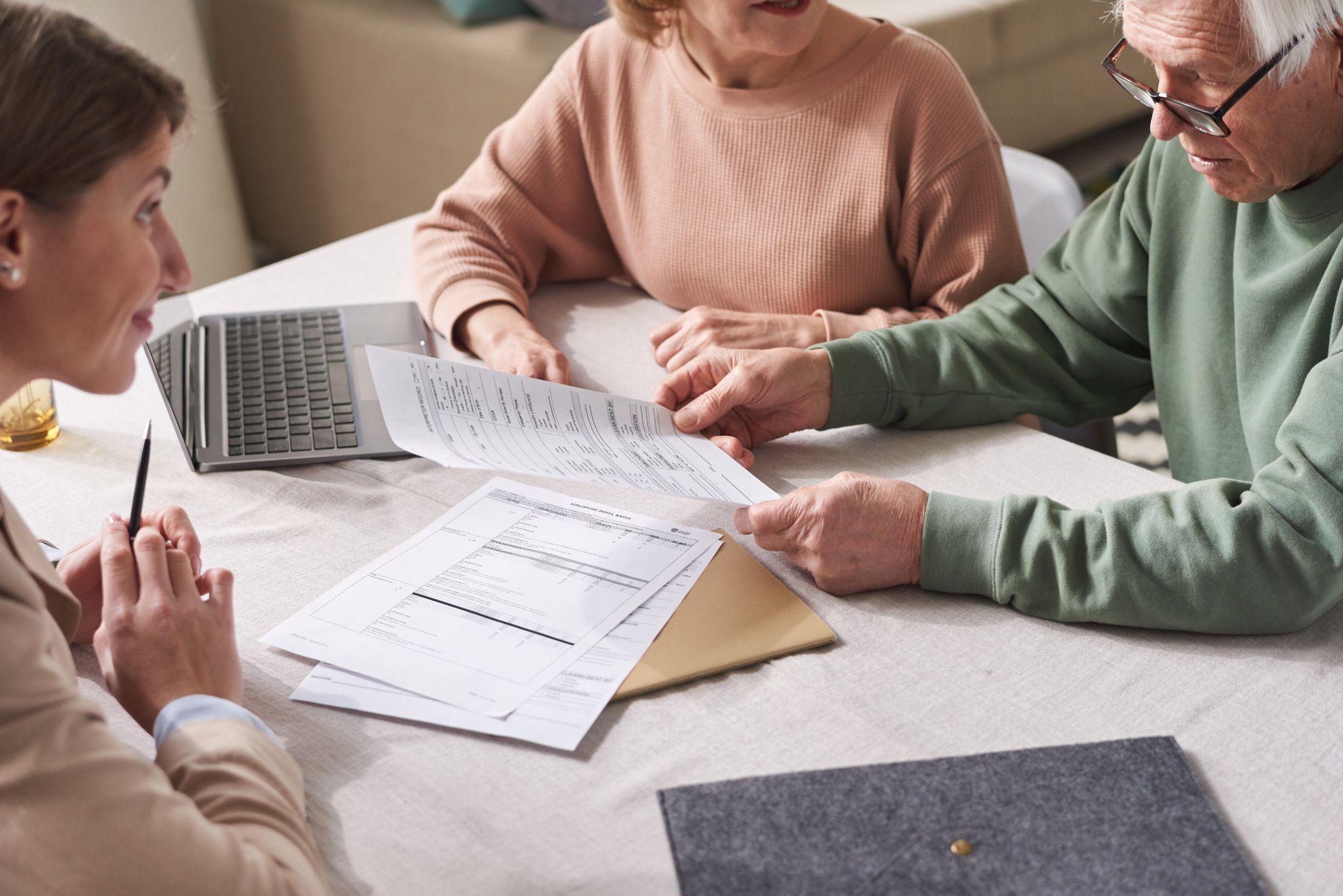 Family reviewing hospital bed rental paperwork and insurance documents