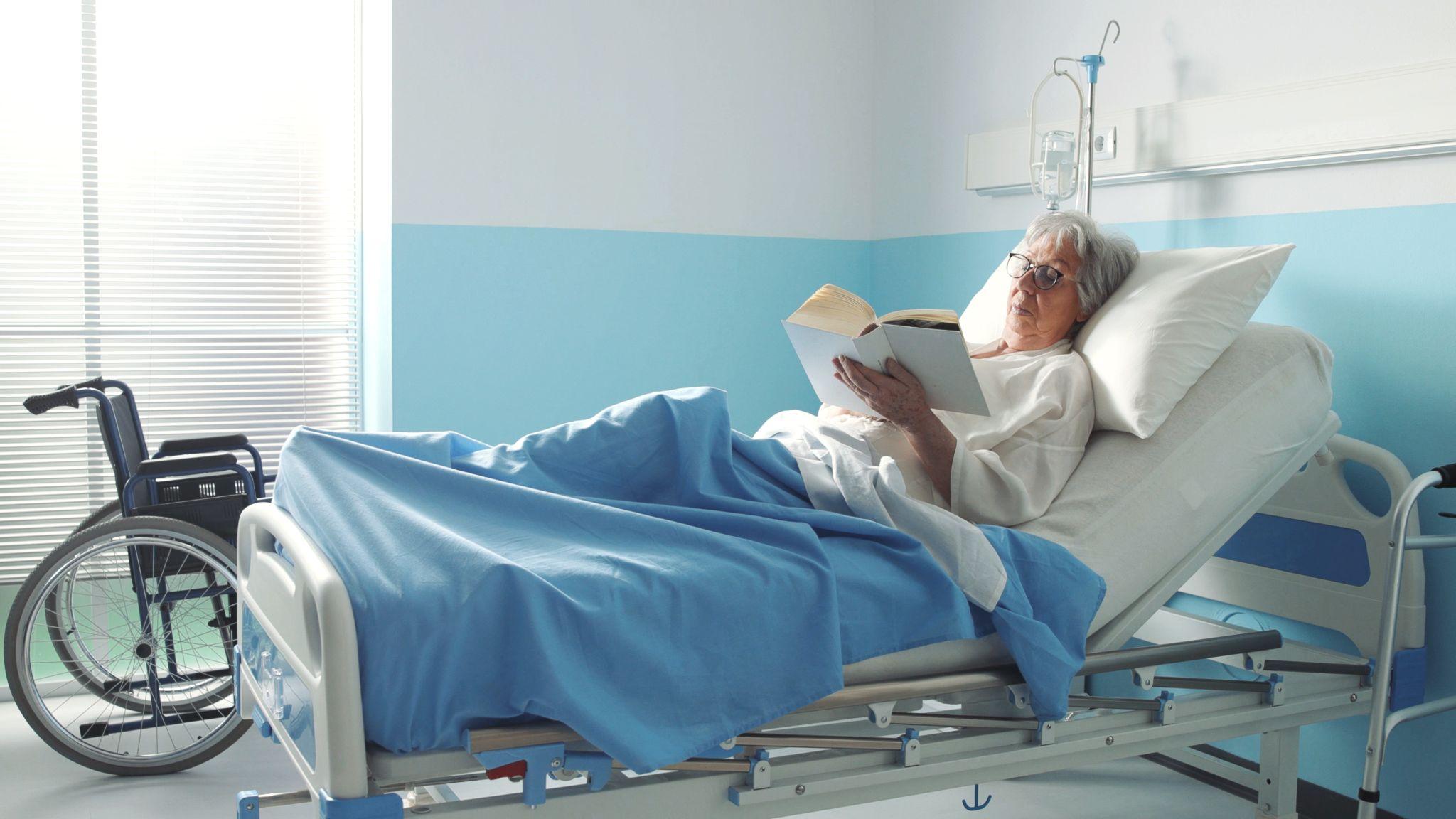 Woman resting comfortably in an adjustable hospital bed during recovery