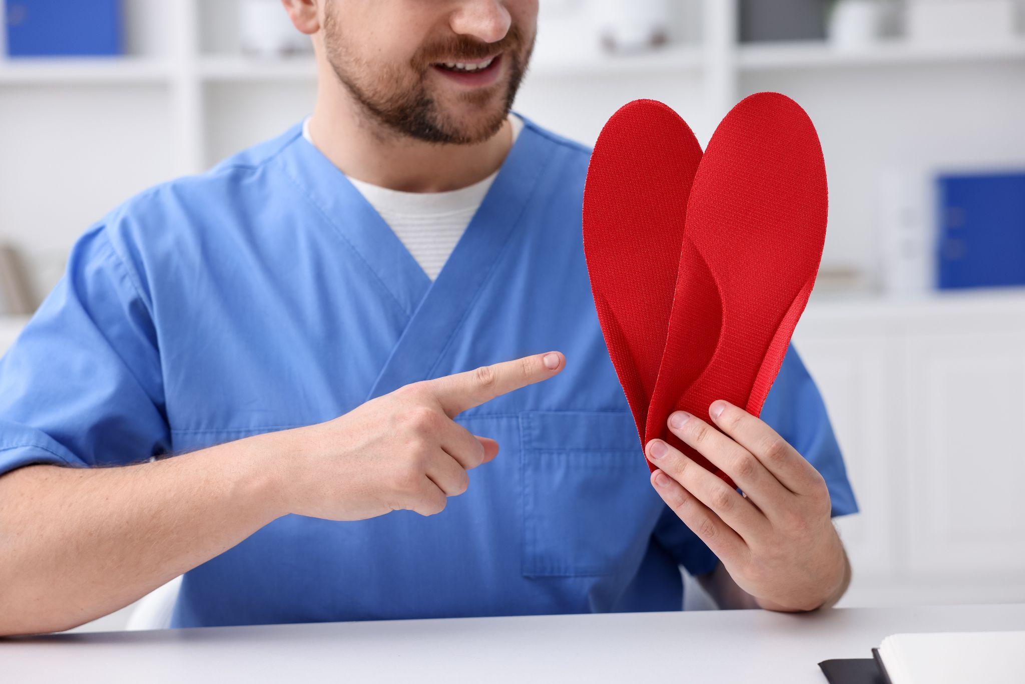 Healthcare professional explaining shoe insoles for everyday foot support
