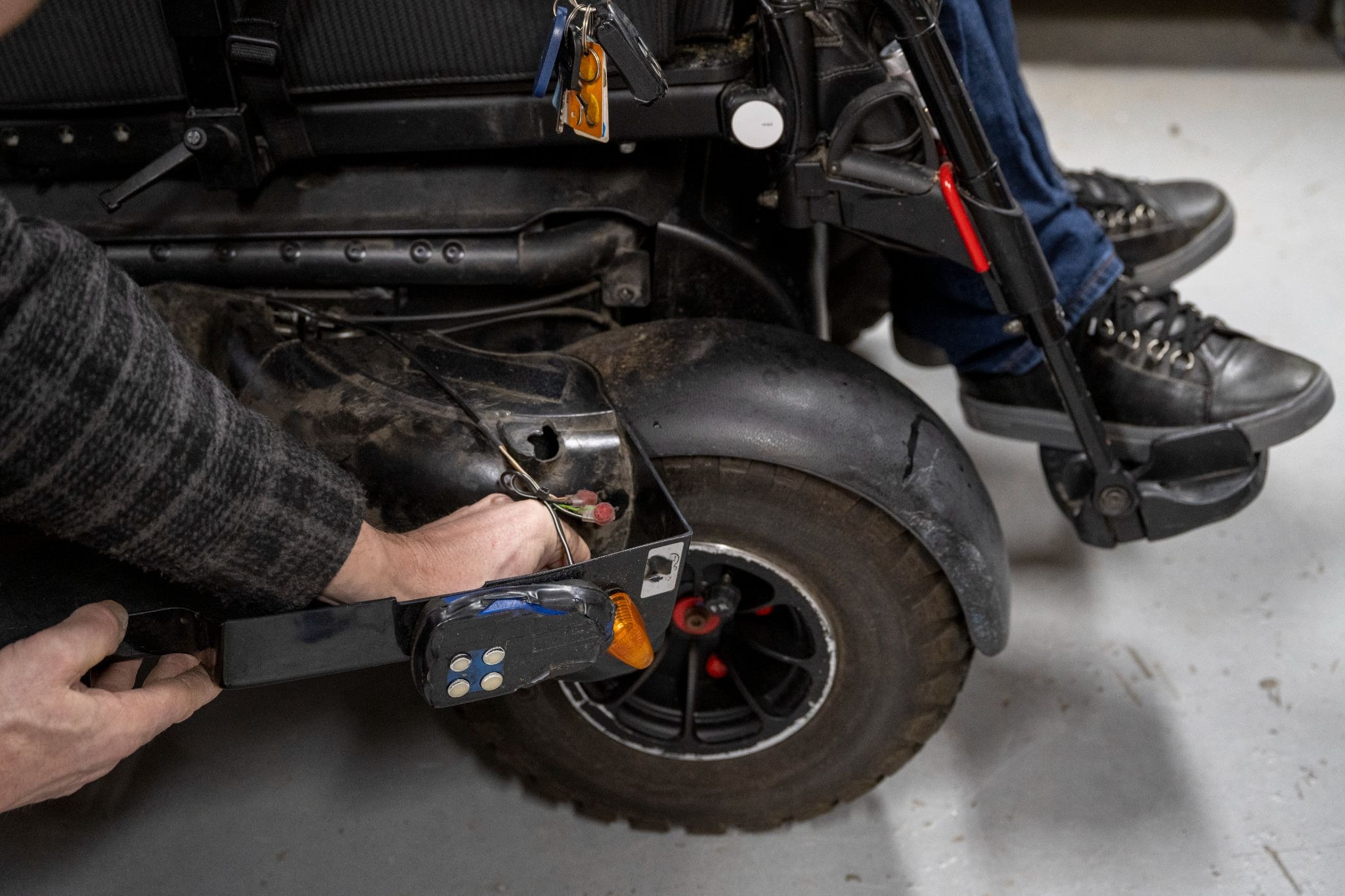 Technician repairing an electronic powered wheelchair mobility device