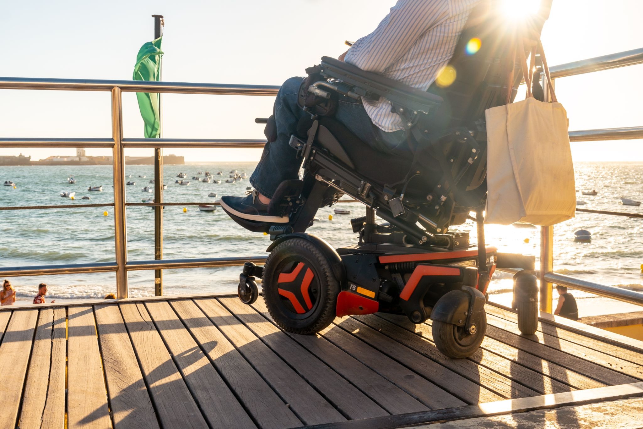 Person using a powered wheelchair outdoors for greater mobility and independence